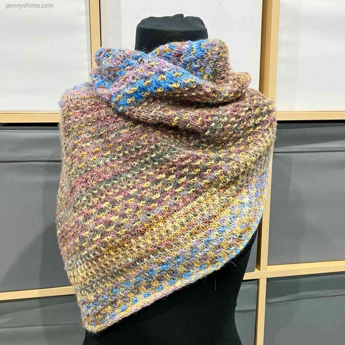 Shift cowl in blue/purple; green/rose, and golds shown on a black covered mannequin/dressform.