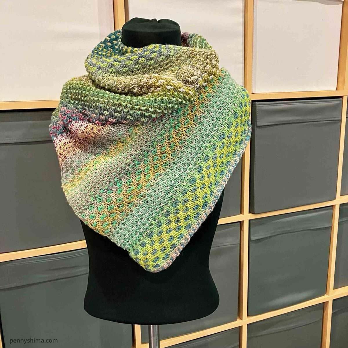 Shift cowl in blues, greys /golds, and greens/rose shown on a black covered mannequin/dressform.