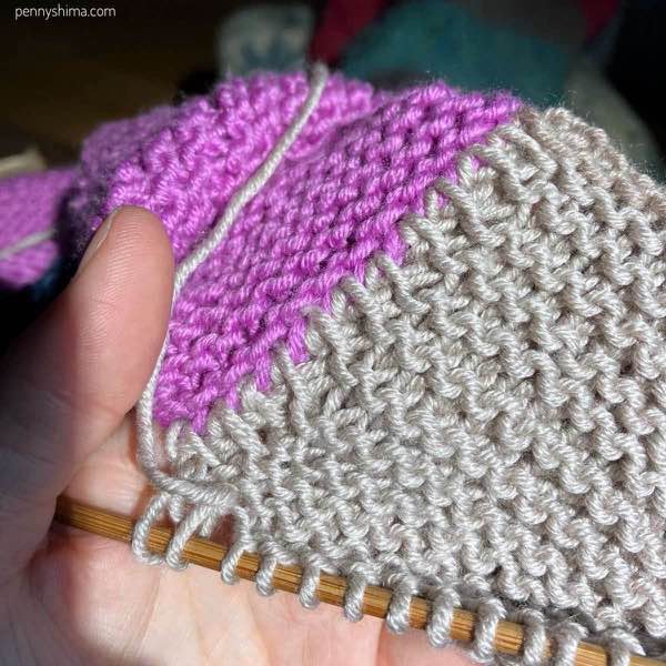 Pink and tan garter stitch knitting in progress