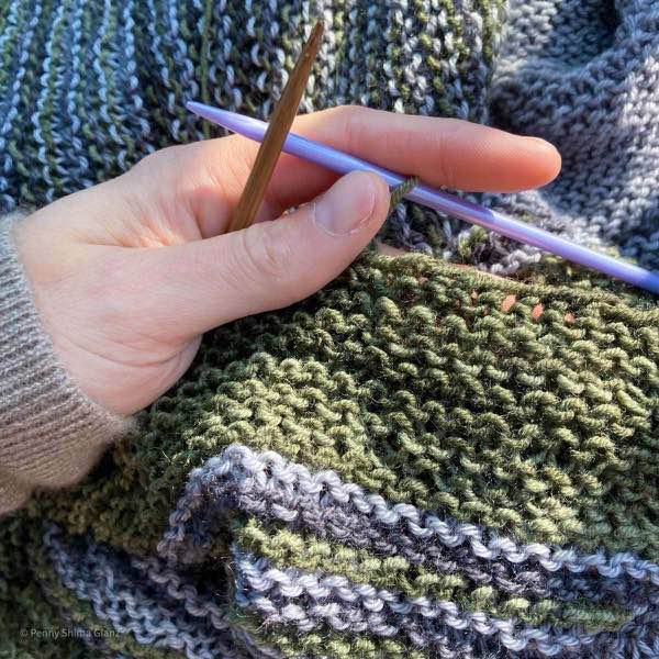 Binding off the grey and green striped shawl