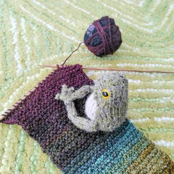 frog in progress on handspun scarf in progress