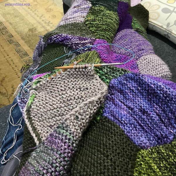 Blanket in progress shown on the knitter’s lap