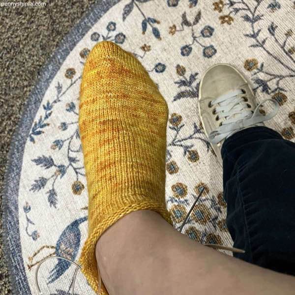 right foot showing a golden yellow sock in progress