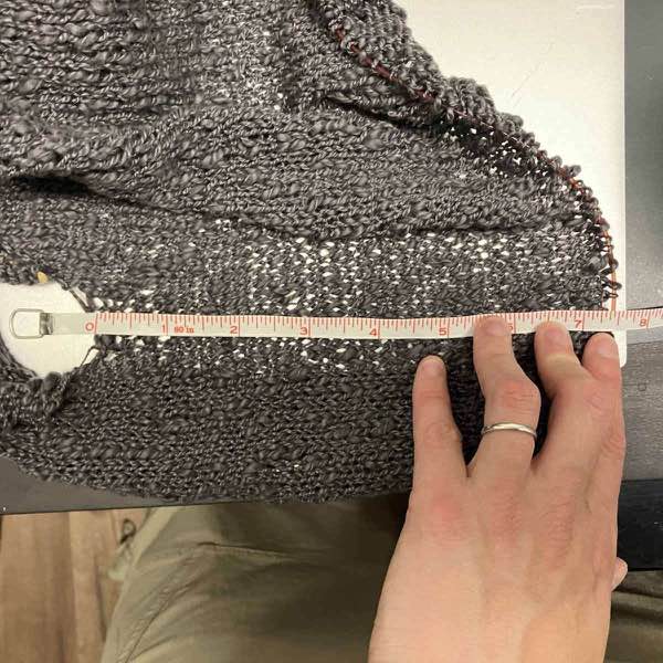 sweater body measures about 7.25 inches with white tape measure.