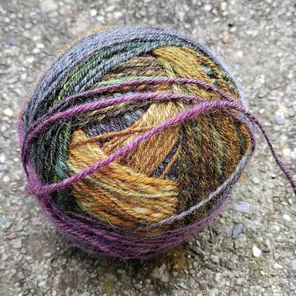 handwound ball of handspun, muted autumn rainbow