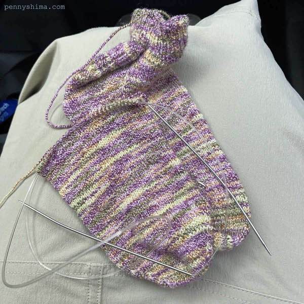 Purple cotton sock with second sock (in progress) on top