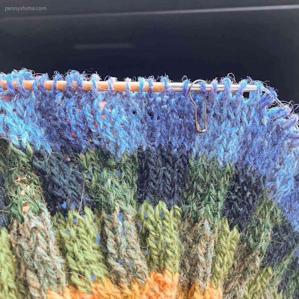 Subtle shifts in sweater yoke color blues being worked.