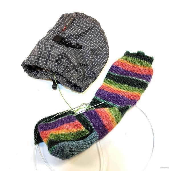 Knit sock in progress, Crew color by Lion Brand. Shown with small Tom Bihn stuff sack