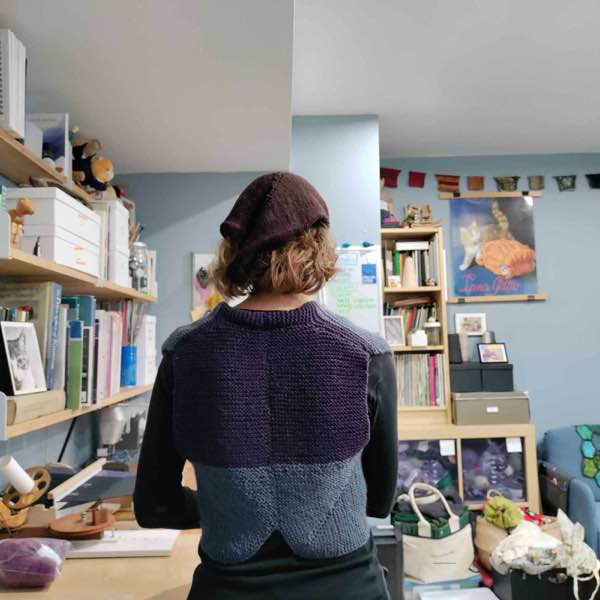 Rib Warmer Vest back view, shows purple contrast and collar