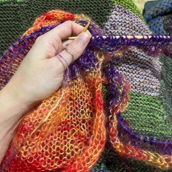 silk mohair 2ply cardi purl side with some of the purple of the front and back showing.