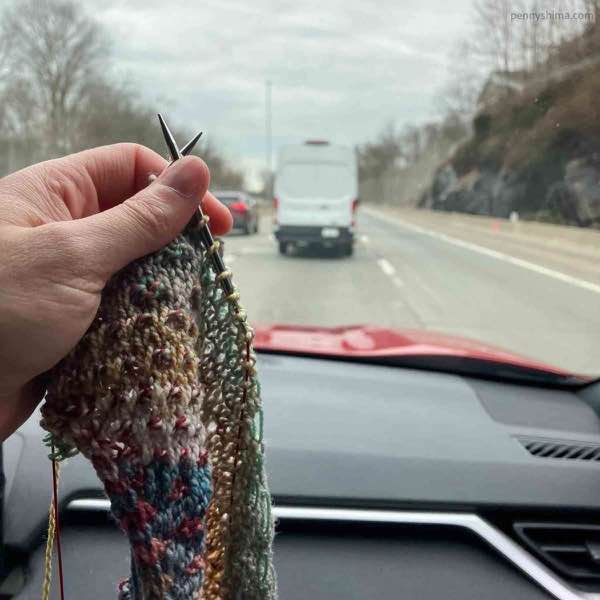 shift being knit in a moving car with grey skies