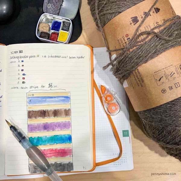 notebook page with watercolor swatch of yarn colors and potential layout. including some basics numbers for width.