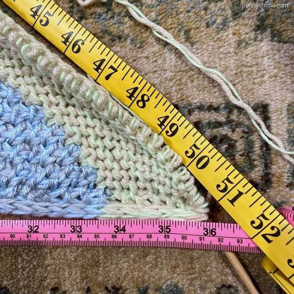 two tape measures showing a 36 inch side of a right angle triangle and about 50.9 inch hypotenuse