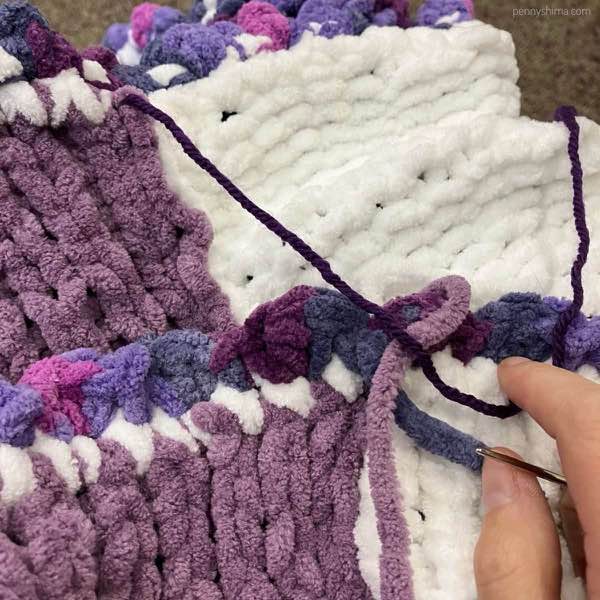 a blanket with ends being woven in.