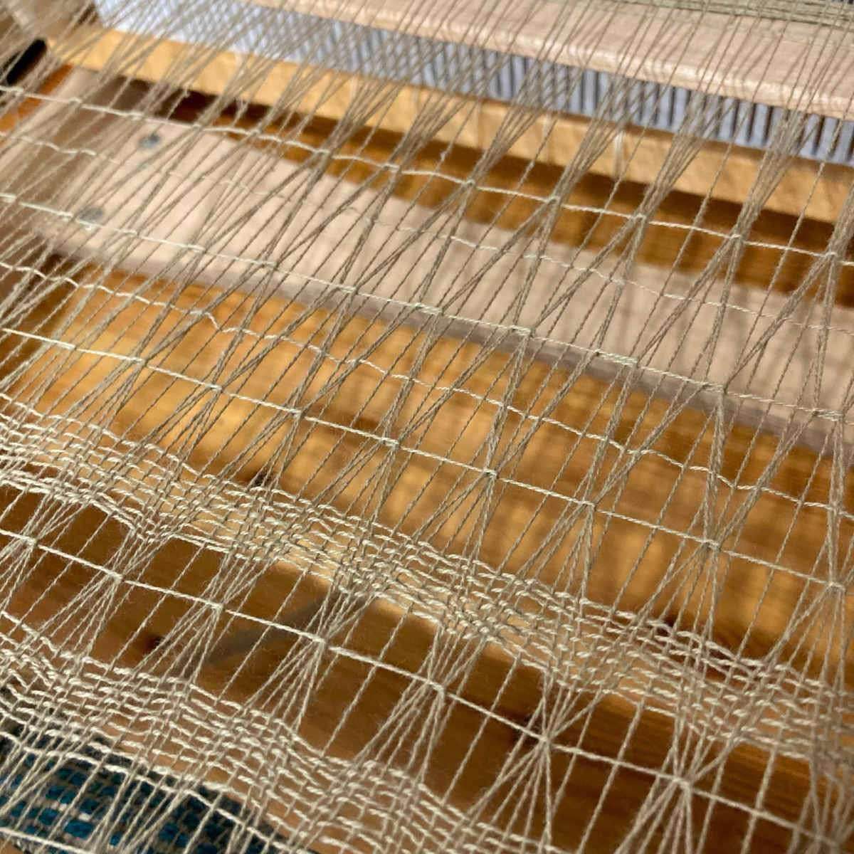 Contiuued weaving in the 20/2 yarn (a neutral/ecru shade) that almost matches the crichet loom. There is a row of 4 thread brooks bouquet followed by 9 even pics, followed by 4 thread brook's bouquet offset with by two threads and one even pick.