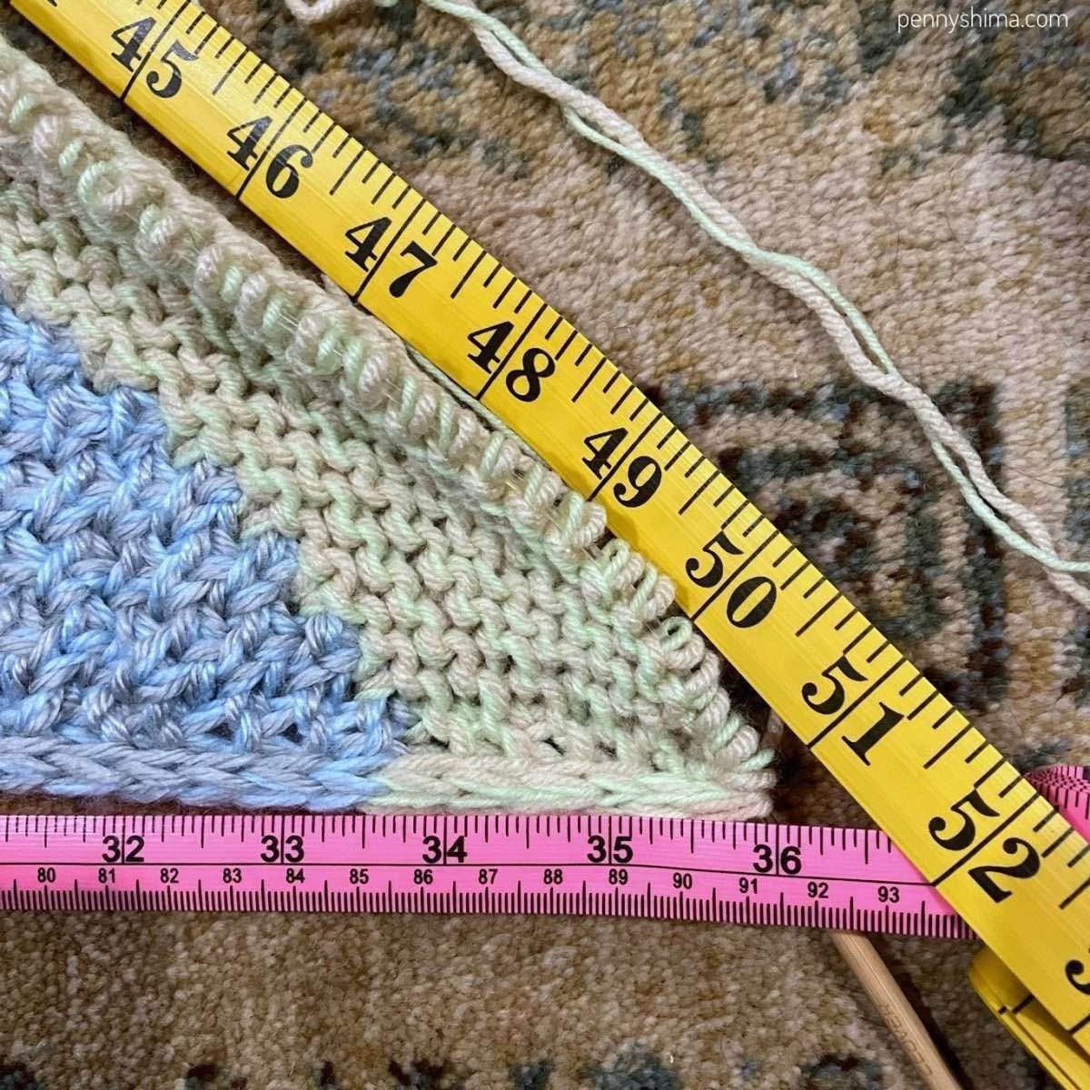 two tape measures showing a 36 inch side of a right angle triangle and about 50.9 inch hypotenuse